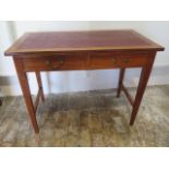 A circa 1900's oak writing table with two frieze drawers on tapering legs - in polished