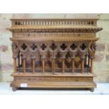 An interesting carved wooden Ecclesiastical wall display cabinet with two drawers and two doors -