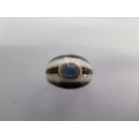 A 9ct rose gold ring with a plain shank and graduating wide domed head with blue enamelled inside