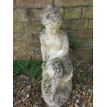 A garden statue of a seated lady - Height 60cm