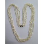 A five string seed pearl necklace with an 18ct diamond and sapphire clasp - Length 80cm - good