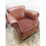 A good quality modern leather club chair with tan leather studded upholstery - in good condition