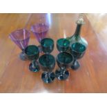 Six green glass goblets - Height 13cm - a green glass decanter with silver cross cork and a pair