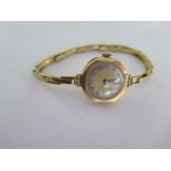 An 18ct yellow gold manual wind ladies wristwatch on 18ct sprung strap - running - approx weight