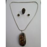 A large amber pendant brooch on a silver chain - brooch 61mm x 34mm - a silver amber ring and a pair