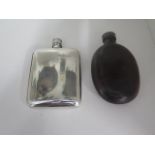 A pewter hipflask 14cm x 9cm and a leather covered hipflask