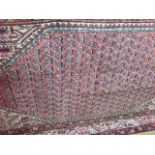 A hand knotted woollen Araak rug - 2.05m x 1.22m