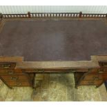 A late 19th century arts and crafts mahogany breakfront desk with nine drawers - one drawer