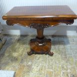 A 19th century rosewood fold over tea/side table on a turned column and circular platform base -