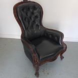 A 19th century Midland Railway mahogany waiting room chair upholstered in buttoned leather on