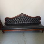 A 19th century mahogany Midland Railway waiting room bench with buttoned leather upholstery on