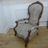 A Victorian carved walnut spoon back upholstered open armchair - Height 104cm x Width 69cm - in good