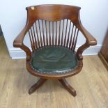 A revolving 1920's office swivel chair with leather seat - Height 75cm x Width 62cm x Depth 62cm -