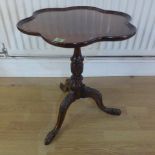 A mahogany side table with a shaped top on a carved tripod base - Height 61cm x Width 51cm
