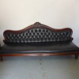 A 19th century mahogany Midland Railway waiting room bench with buttoned leather upholstery on