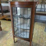An Edwardian mahogany and inlaid display cabinet with a leaded glazed door - missing its gallery -