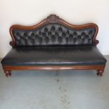 A 19th century mahogany Midland Railway waiting room bench with buttoned leather upholstery on