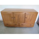 A Ercol elm side cabinet with three doors and two doors with internal cutlery drawer - good