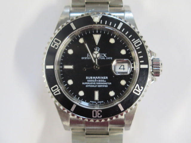 A Rolex stainless steel Oyster Perpetual date Submariner bracelet wristwatch model 16610 serial