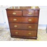 A walnut chest of two over three graduated drawers on a plinth base - in polished and restored