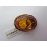 A 9ct yellow gold engraved amber brooch - 28mm x 20mm - ex jewellers stock