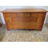 An oak multi seven drawer sideboard (matching previous lot) - Height 85cm x 155cm x 47cm - in good