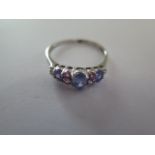 A 9ct white gold Tanzanite, pink sapphire and diamond ring size R - approx weight 1.6 grams - with