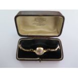 A 9ct yellow gold manual wind Tissot ladies wristwatch on a sprung 9ct strap - total weight approx