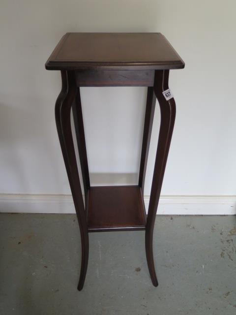 An Edwardian mahogany satinwood crossbanded ebony and box strung two tier jardiniere/plant stand -