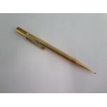 A 9ct yellow gold cased propelling pencil - Length 12cm - approx 23.2 grams - some small denting but