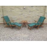 A pair of teak steamer garden chairs and a coffee table with cushions - as new