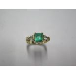 An 18ct yellow gold emerald and trillion cut diamond ring - emerald approx 1.5ct, emerald is a