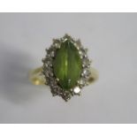 A hallmarked 18ct yellow gold peridot and diamond ring size I/J - approx weight 4.2 grams - head