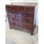 A Georgian mahogany chest of two over three drawers, the cock beaded drawers with bun handles, the