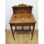 An inlaid mahogany writing table with a lift up sloping top enclosing a fitted interior and upstand