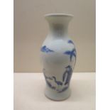 A heavy blue and white oriental design vase - Height 21cm - generally good