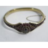 A silver gilt hinged garnet bracelet - 6.5cm x 6.5cm external - head approx 1.8cm - in good