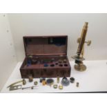 A Victorian brass microscope by J Cooke York with mahogany box and assorted fittings