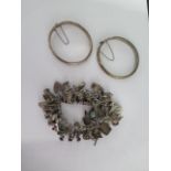 A silver charm bracelet and two silver bangles - total weight approx 143 grams