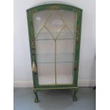 A 1920's Japanned green lacquered display cabinet, domed cabinet with single glazed door, two