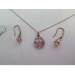 A 9ct rose gold pink multi stone pendant and a pair of 9ct rose gold pink multi stone drop