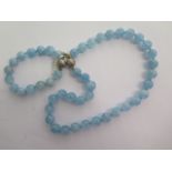 An aquamarine smooth beaded necklace and an aquamarine smooth beaded bracelet - ex jewellers stock