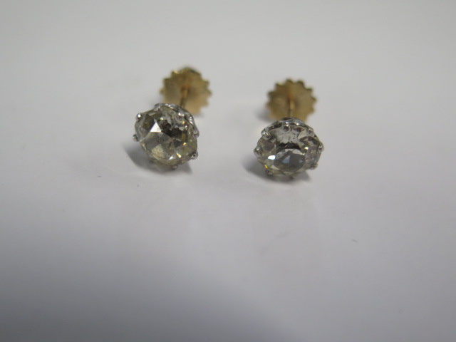 A pair of diamond stud earrings in gold and white metal settings with screw backs - each diamond - Image 2 of 3