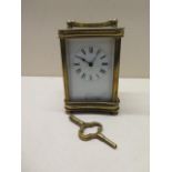 A brass carriage clock - Height 13cm - running with key