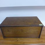 An oak box with beaded trim - Height 20cm x 49cm x 27cm - in polished condition