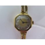 An 18ct yellow gold manual wind ladies wristwatch on 18ct sprung strap - running - approx weight