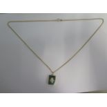 A 14ct yellow gold Jade pendant on a 14ct 60cm chain, pendant 2cm x 1.5cm - some small chips to Jade