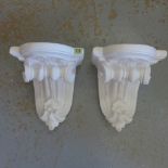 A pair of plaster scroll wall brackets, 34cm tall x 28cm wide x 27cm deep