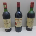 Two bottles of Chateau Leoville Poyferre 1970 red wine - one level below neck, others at base of