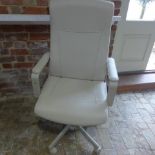 A modern faux leather cream office chair